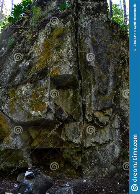 Big Cliffs In Forest Large Geometric Rough Stone Rock Overgrown With