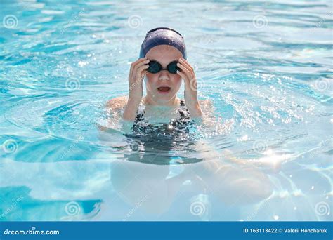 Face Of Young Women Swimmer In Pool Girl In Cap Goggles For Swimming