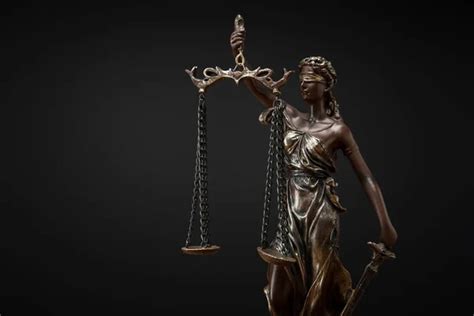 Bronze Statuette With Scales Of Justice Isolated On Black Stock Image