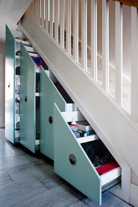 An Under The Stairs Storage Unit With Drawers Underneath It Is Shown In