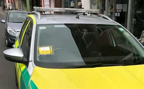 traffic warden faces backlash after slapping parking ticket on ambulance while paramedic takes