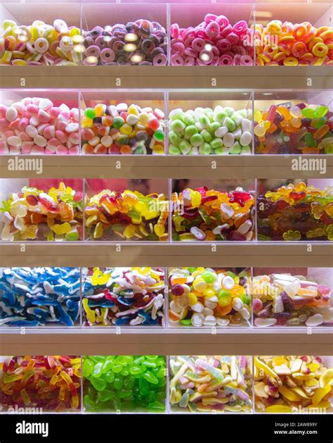 many colorful sweets on display for pick and mix in a candy shop stock