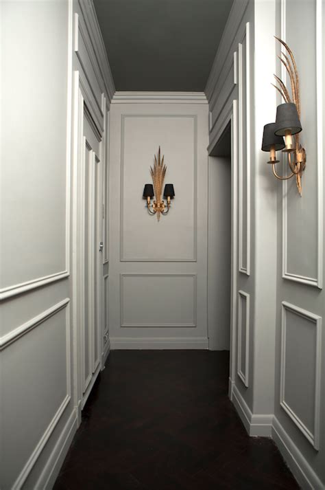 Dramatic Panelled Hallway With Dark Floor Dark Ceiling And Gold Leaf