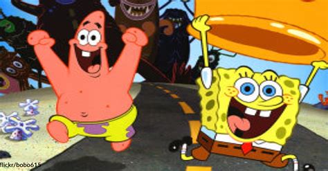 spongebob and patrick dancing on the road with their hands up in the air