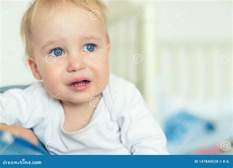 Cute Caucasian Blond Toddler Boy Portrait Crying At Home During