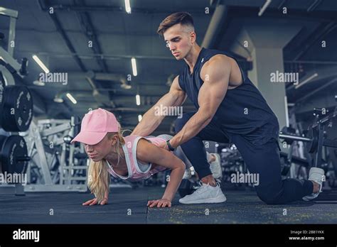 Fitness Instructor Help Girl To Do Push Ups On Training In Fitness