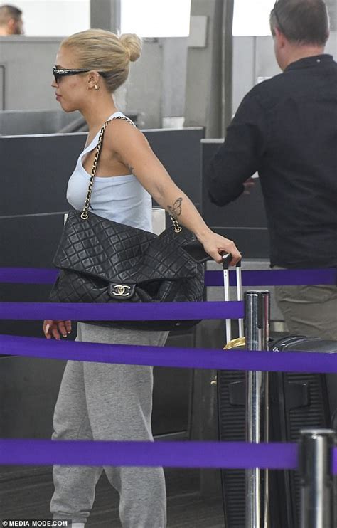 Tammy Hembrow Emerges Barefaced And Braless In A Baggy Sweats As She Touches Down On The Gold