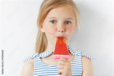 Headshot Of Adorable Preschool Female Child Holding Popsicle And