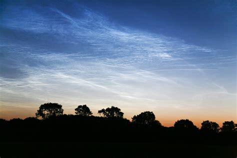 Photographs Of Noctilucent Clouds Appearing In The Night Sky Over