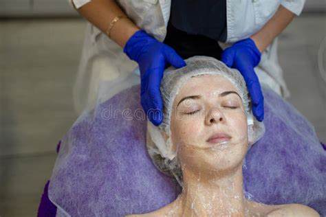 Beauty Clinicwoman Gets A Professional Facial Procedure Beautician Makes Massage On A Woman`s