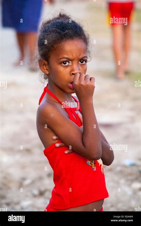 daily life in cuba cuban girl with thumb in mouth with out of focus legs at cienfuegos cuba