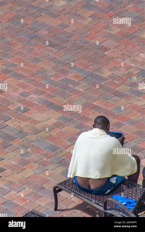Black Man Exposing His Butt Crack While Sitting On Lounge Chair Stock