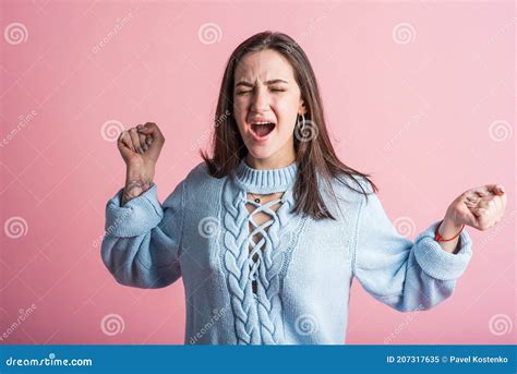 Portrait Of A Brunette Girl Who Screams After A Quarrel In The Studio