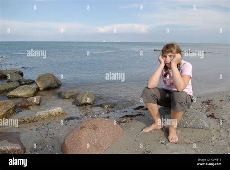 Girl Siting At The Baltic Sea Beach From Maasholm Schleswig Holstein