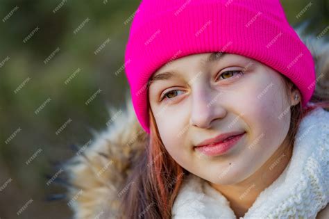 Premium Photo Outdoor Portrait Of Girl Wearing Warm In A Pink Hat
