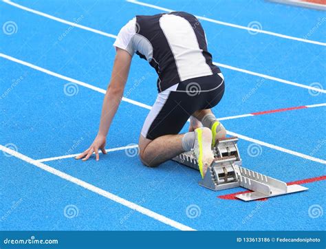 Athlete In The Starting Blocks Of A Athletic Track Before The St Stock