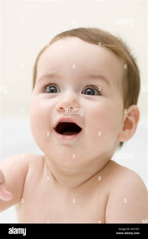 6 Month Old Caucasian Baby Girl Looking Happy And Excited Stock Photo