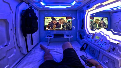 Taz experiences what it's like to stay inside the very cramped living conditions of a capsule pod hotel. Photo: Spaceship Capsule Hotel Room | Vinjatek