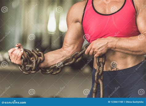 The Bodybuilding Girl Is In The Gym With A Chain In Her Hands Stock