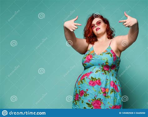 Extra Cool Plus Size Overweight Redhead Lady In Sunglasses Shows A Gesture Sign Finger Gun