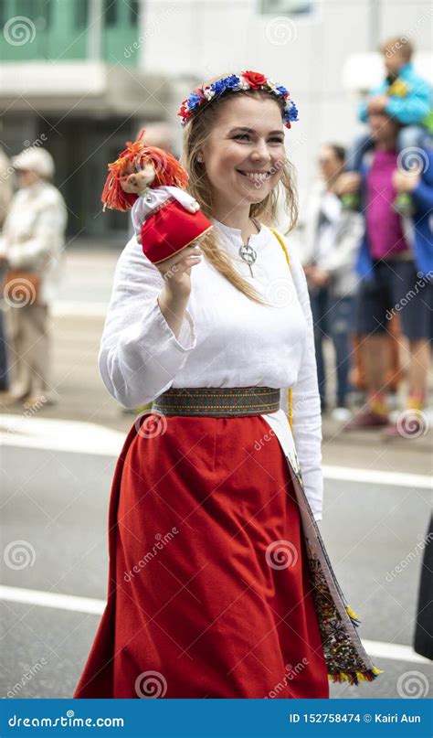 Estonian People In Traditional Clothing Walking The Streets Of Tallinn