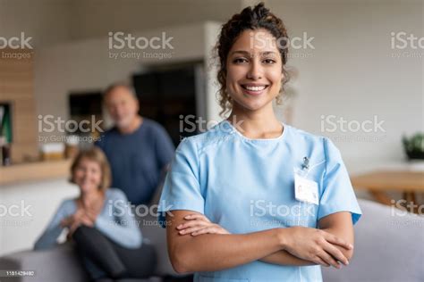 Portrait Of A Home Caregiver With Two To Senior Patients Stock Photo