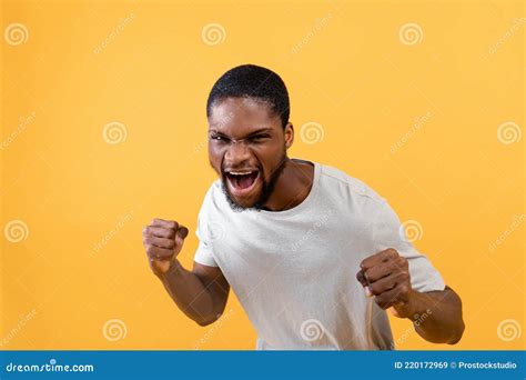 Young Black Man With Fists Defense Gesture Shouting With Rage