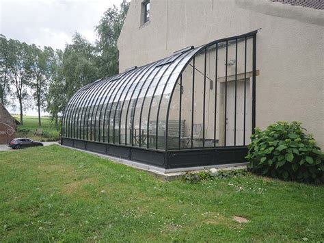 Greenhouses are not just used for special plants. DIY lean to greenhouse with curved wrought iron roof - DBG ...