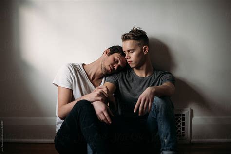 Young Gay Male Couple In Love Sitting On Bedroom Floor By Stocksy Contributor Jess Craven