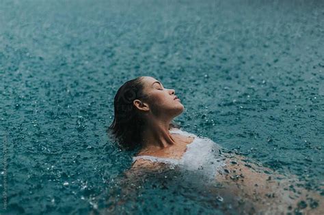 Woman In A Pool Swimming In The Rain By Jessica Sharmin For Stocksy United Pool Photography