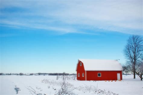 Red Barn House In The Middle Of Snow Field During Daytime · Free Stock