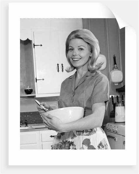 1960s 1970s Smiling Blond Housewife In Kitchen Holding Mixing Bowl