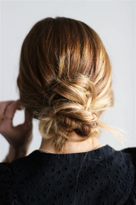 Twist and wrap the hair tie around the bun another time. DIY File: Easy Messy Bun Tutorial - gaby burger