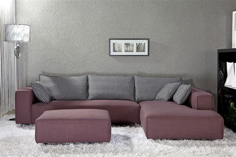 Small Sectional Sofa In Purple With Monochrome Throw Pillows Large White Fluffy Area Rug A Free Standing Lamp With Silver Lampshade 