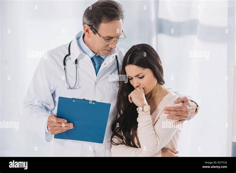 Male Doctor Hugging Upset Female Patient Stock Photo Alamy
