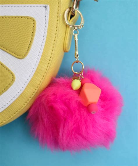 Check out this tutorial to see how easy they are to make! Simple DIY Pom Pom Keychain | FaveCrafts.com