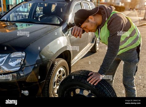 Transportation Traveling Concept Worker Changes A Broken Wheel Of A Car The Driver Should