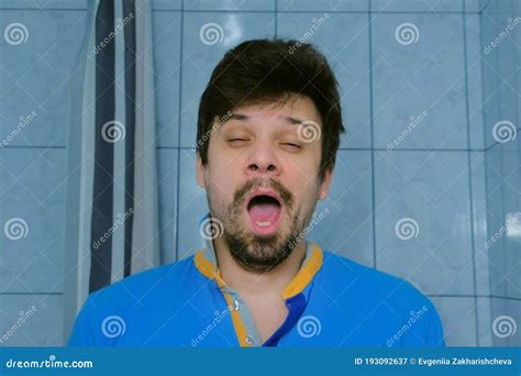 Sleepy Tired Young Man Is Yawning At Morning In Bathroom Looking At Camera Stock Image Image