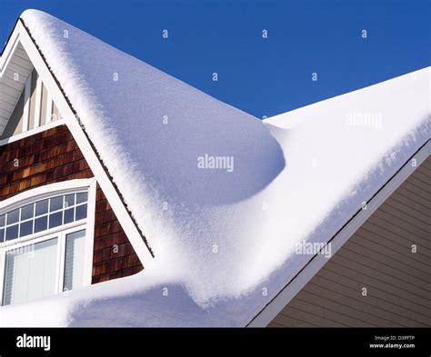 Snowy Roof A Thick Blanket Of Snow Covering The Steep Roof Of An