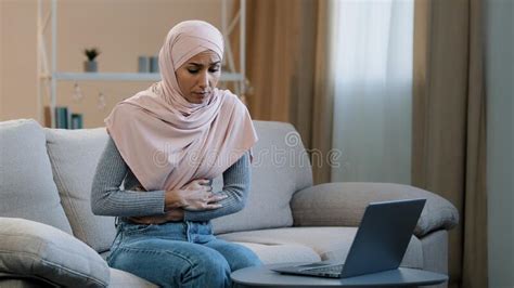 Young Business Woman Muslim Islamic Arab Girl In Hijab Sitting On Sofa