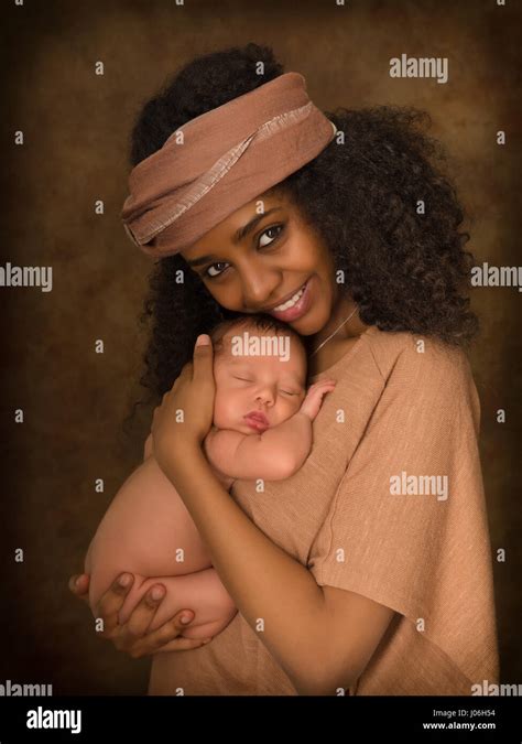 Ethiopian Young Mother Holding Her 7 Days Old Little Baby Against A