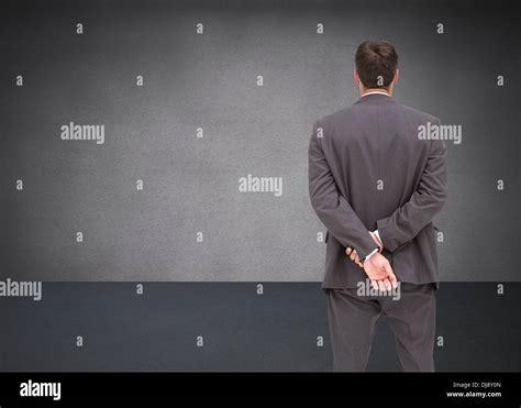 Businessman Standing With Hands Behind Back Stock Photo Alamy