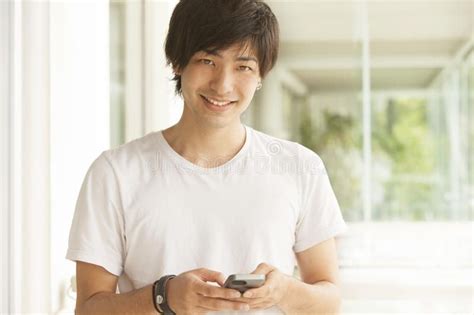 Happy Japanese Man With Mobile Phone Sending Text Message Ad Man