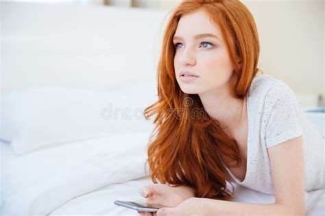 Redhead Woman Lying On The Bed With Smartphone Stock Photo Image Of