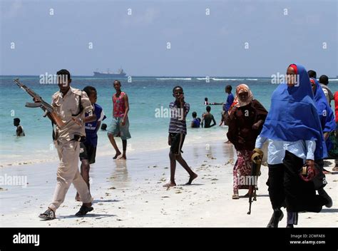 A Somali Police Officer Patrols Lido Beach As Residents Relax Hi Res