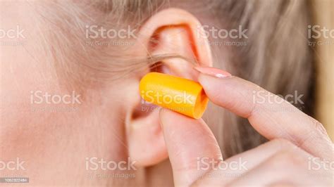 Woman Putting Earplugs Stock Photo Download Image Now Adult Adults
