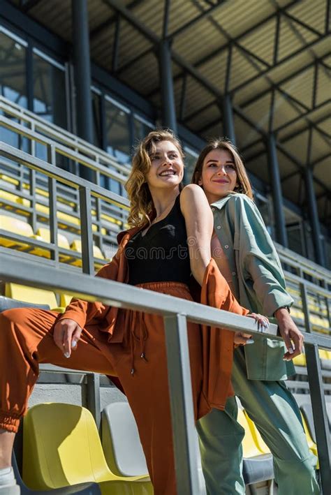 Two Slim Sporty Young Women Relax After Exercise Sitting On The Seats