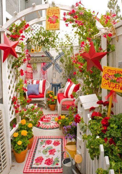 An Outdoor Area With Red And White Furniture Potted Plants And Flowers