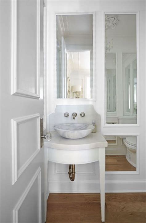 French Powder Room Features A Small White Washstand With Tapered Legs