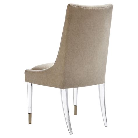 Made from solid ash wood, this chair features tapered legs and flowing arms for a stylish and stable seat. Caracole IM Floating! Modern Classic Acrylic Upholstered Taupe Dining Chair